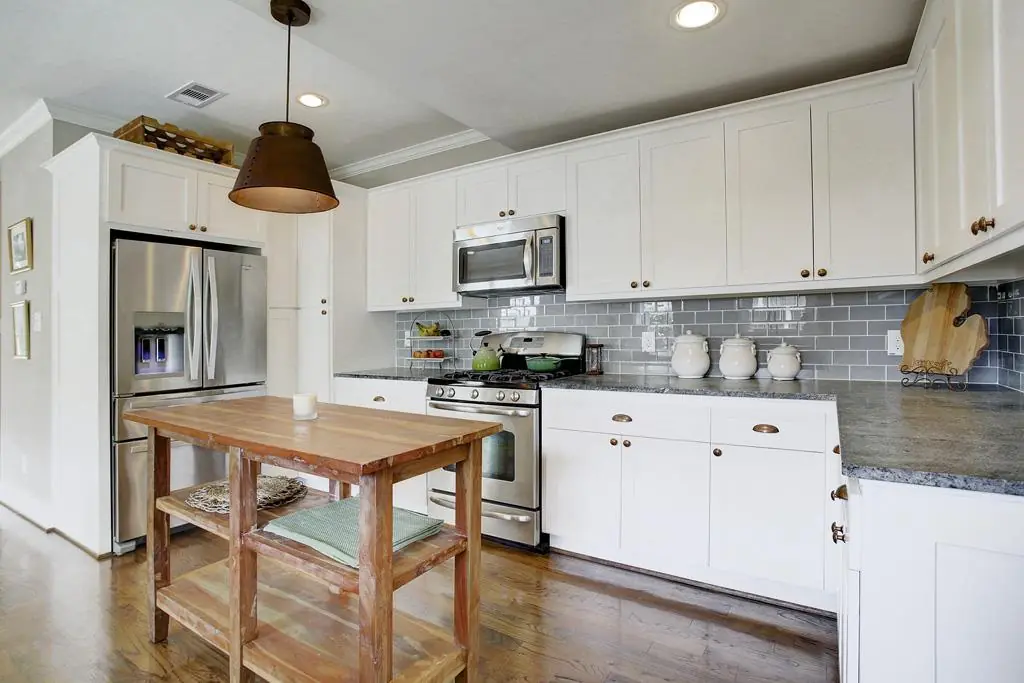 White cabinets, small island for a unique Kitchen space